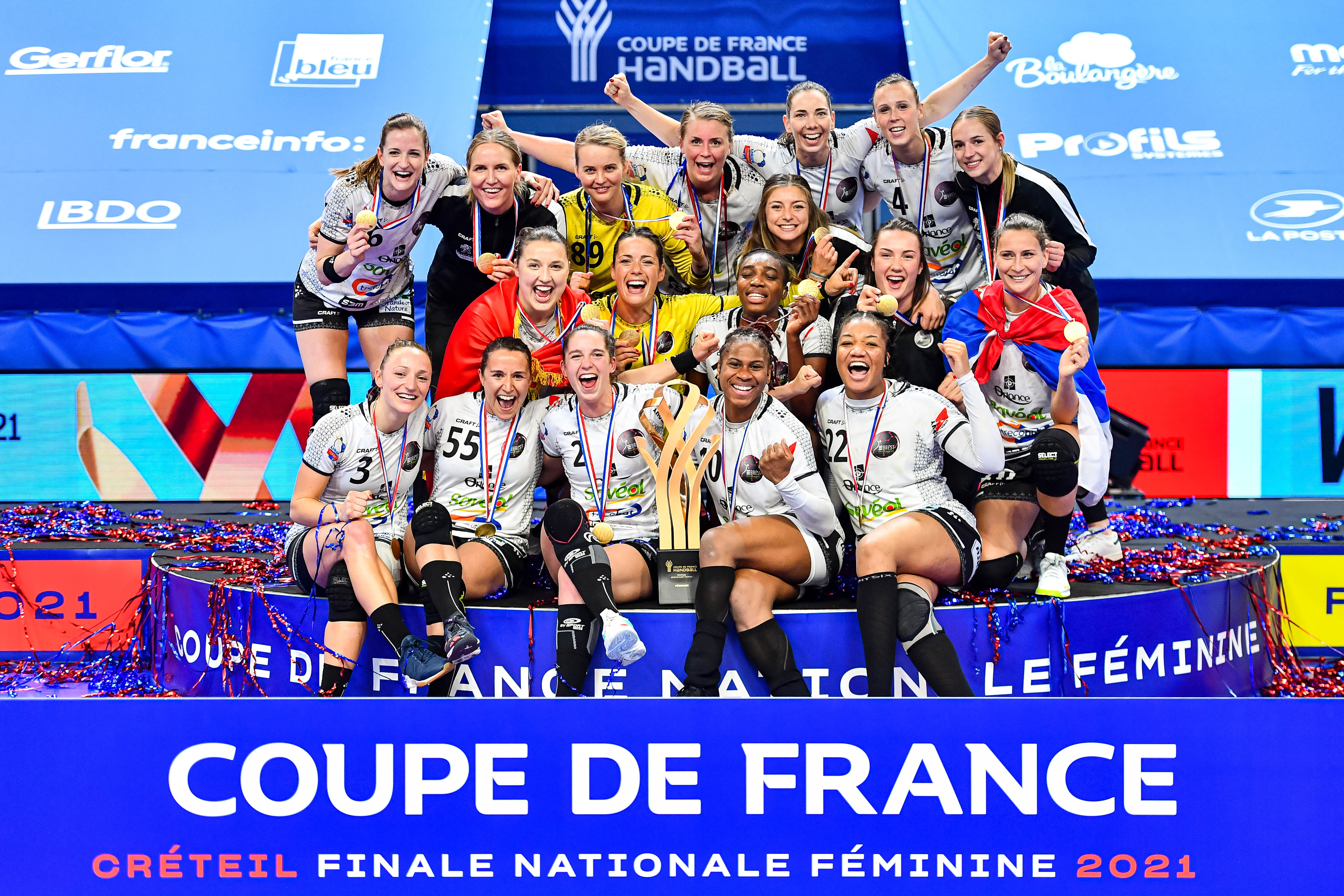 Players of Brest celebrate their victory with the trophy during the women's French Cup handball final match between Nantes and Brest on May 15, 2021 in Creteil, France. (Photo by Baptiste Fernandez/Icon Sport)